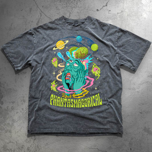 Washed gray Intergalactic Mindmelt tee flat laid on concrete with colorful alien face exposed brain and planets graphic