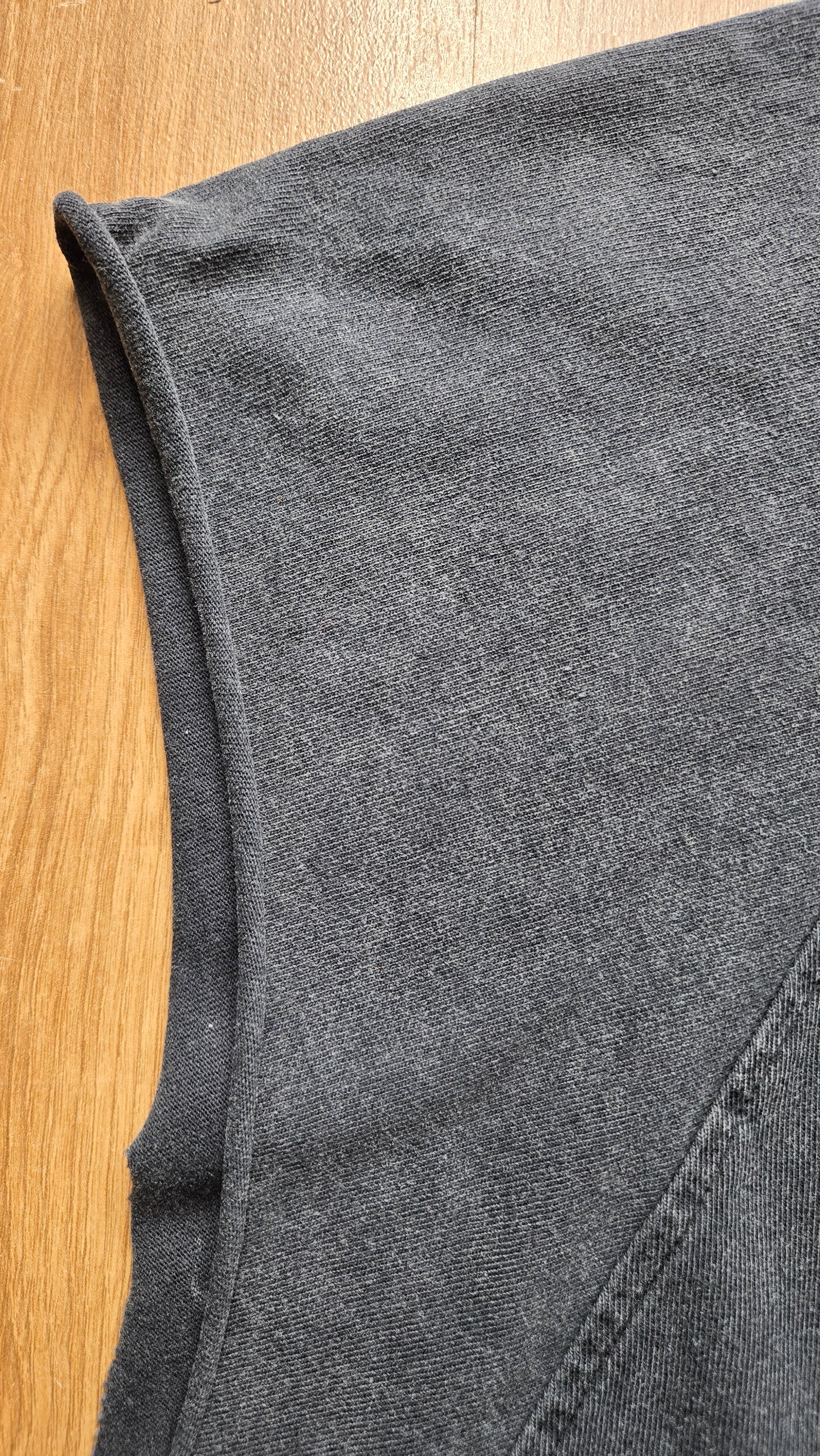 Detail of armhole and side seam on Dimensional Drift snow wash raw hem tank