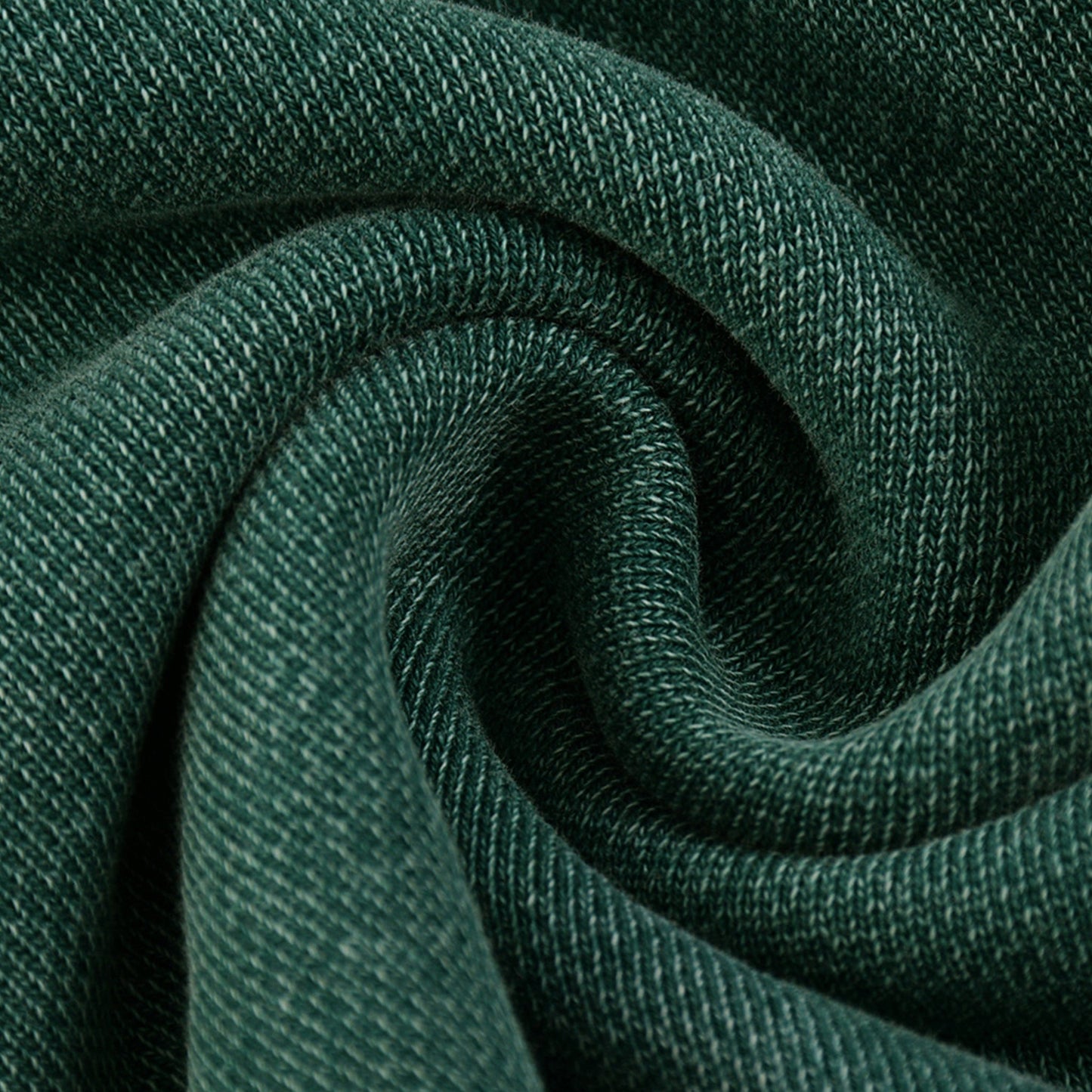 Close-up of dark green Existential snow wash jogger fabric swirled to show texture