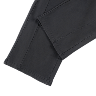 Open uncuffed hem detail on black Spirit Molecule barrel leg sweatpants, showing the deep turned cuff and topstitching