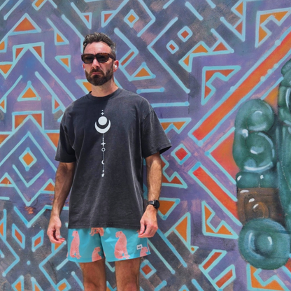Model wearing Existential tee front view with moon phases chest graphic size L against mural