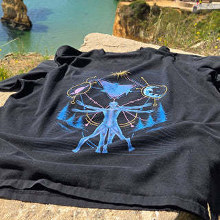 Interconnected charcoal vintage tee laid on seaside rocks showing full cosmic print