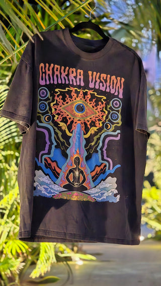 Chakra Vision Fluffy Vintage tee in black wash hanging among tropical palms showing full psychedelic print