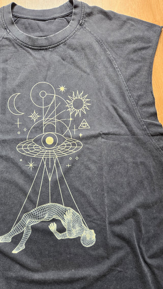 Flat lay of Dimensional Drift snow wash tank showing cosmic eye and figure graphic