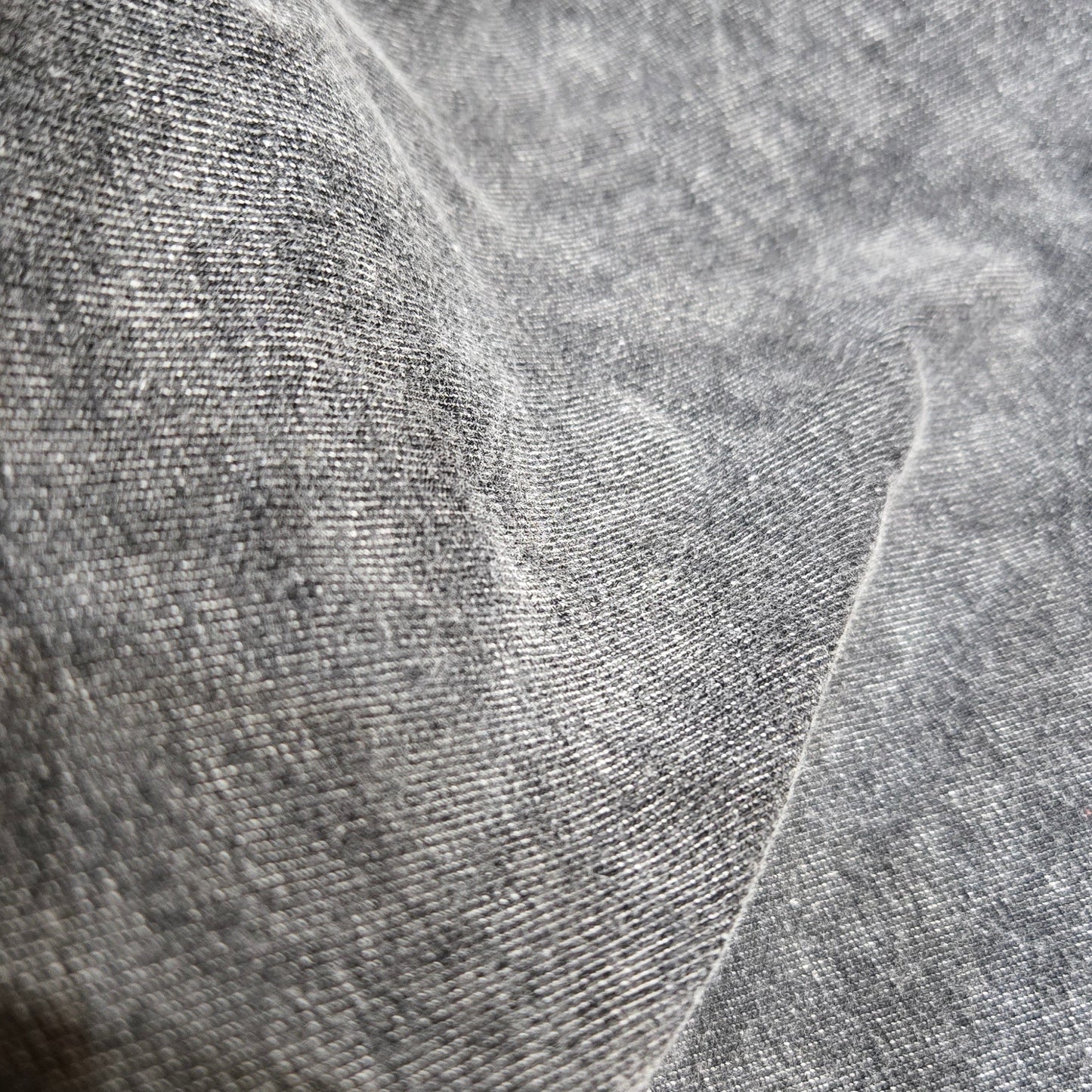 Close-up of textured gray fabric with a subtle pattern