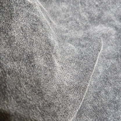 Close-up of textured gray fabric with a subtle pattern
