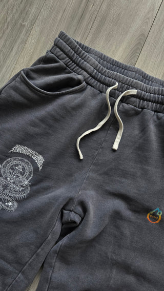 Front waistband of the washed gray Spirit Molecule sweatpants, elastic waist with white drawstring, slanted side pocket and the serpent mandala thigh print