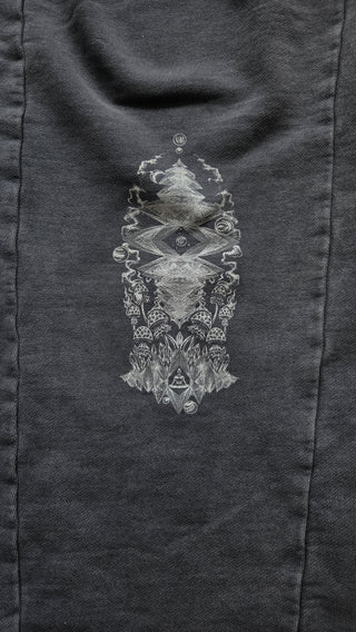 Back leg of the washed gray Spirit Molecule sweatpants, showing the stacked geometric totem print with all-seeing eye, mushrooms and smoke