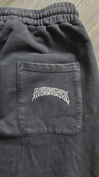 Back patch pocket of the washed gray Spirit Molecule barrel leg sweatpants, printed with the white Phantasmagorical wordmark