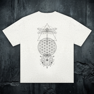 Existential celestial crewneck tee in heather oat, styled flat lay, large black sacred-geometry back print with dragonfly, flower of life, and all-seeing eye