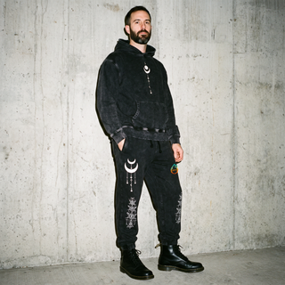 Existential Joggers in black worn with the matching Existential Snow Wash Hoodie, standing, full length.