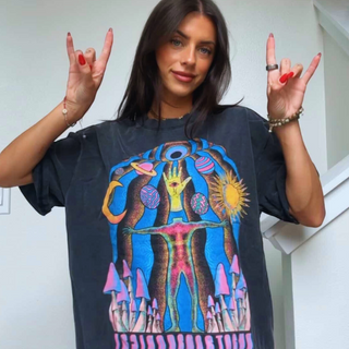 Woman in oversized black Self Actualized tee throwing rock-on hand signs showing psychedelic cosmic graphic