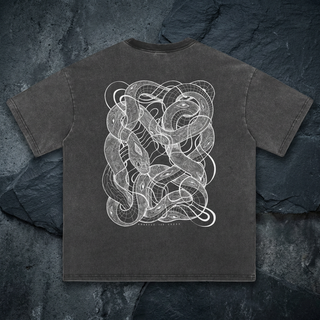 Charcoal Embrace The Chaos fluffy vintage heavyweight tee, back view on dark slate, printed with intricate white line art of tangled serpents and eyes.