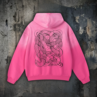 Pink sun fade oversized hoodie, back view with hood up on concrete, printed with black line art of tangled serpents and eyes, an Embrace The Chaos Patakota collab.