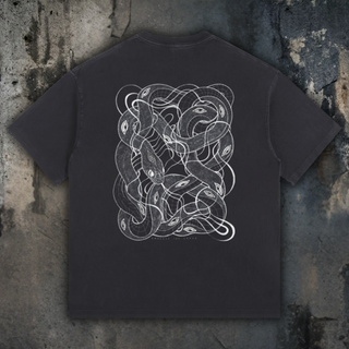 Black t-shirt with white snake design on a textured gray background
