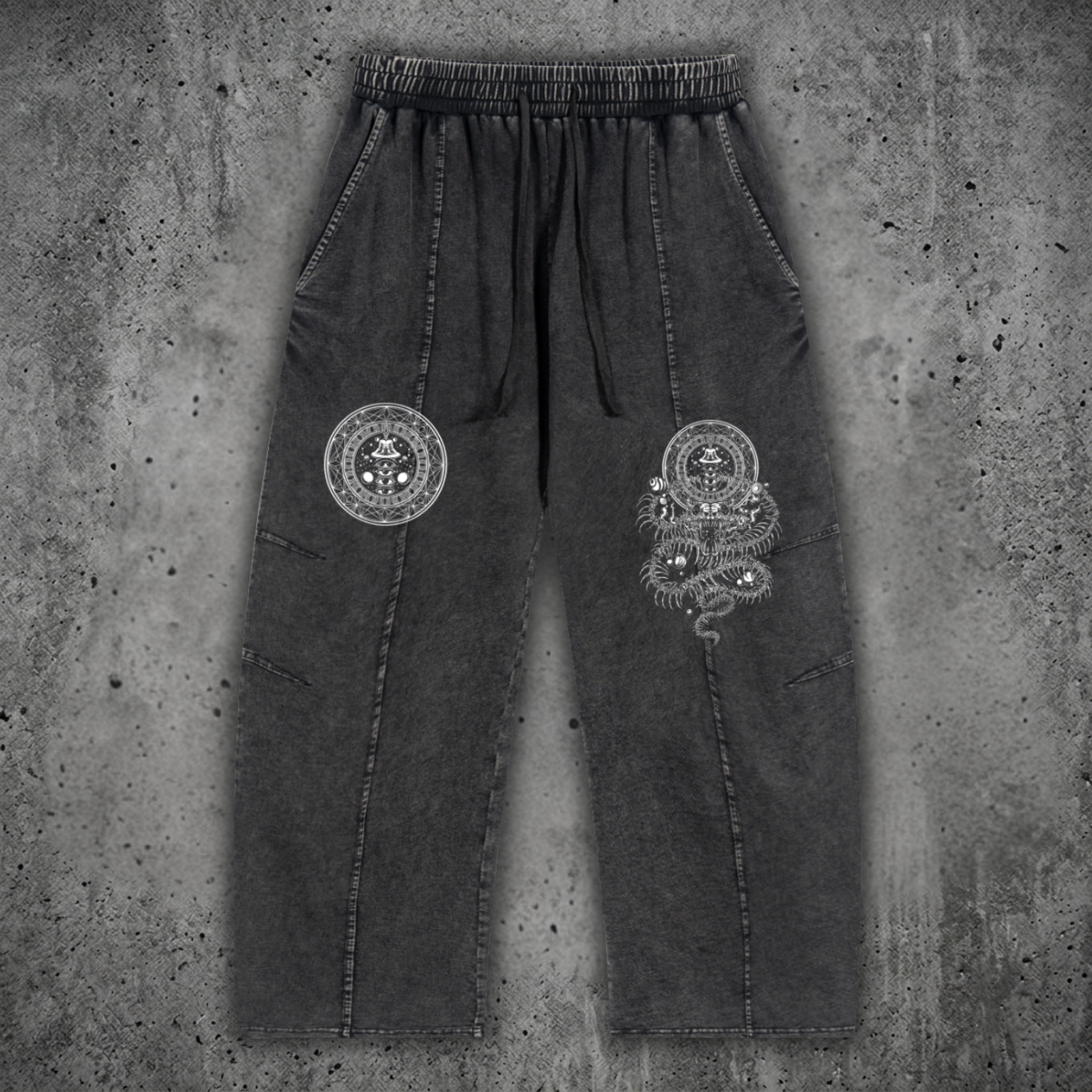 Front view of the DMT.exe snow wash heavyweight drawstring cotton pants featuring an oversized baggy fit, functional pockets, and psychedelic snake artwork on 240 GSM premium cotton.