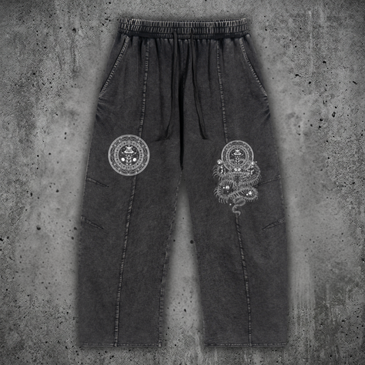 Front view of the DMT.exe snow wash heavyweight drawstring cotton pants featuring an oversized baggy fit, functional pockets, and psychedelic snake artwork on 240 GSM premium cotton.