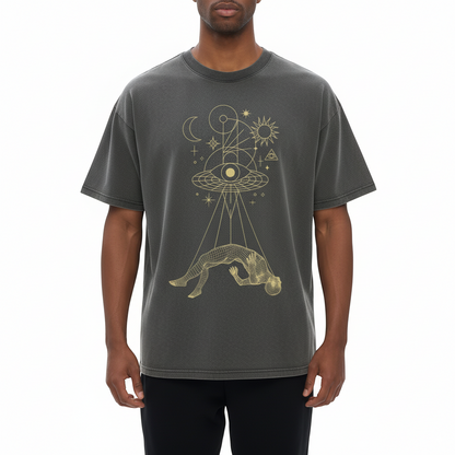 Front view of Dimensional Drift charcoal tee with gold celestial figure and eye graphic