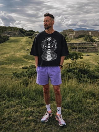 Model wearing the black Cosmic Connection oversized boxy sweater tee, showing the flowy drop-shoulder fit