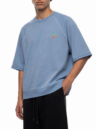Model wearing the Metamorphosis vintage wash short-sleeve sweatshirt, boxy oversized streetwear fit