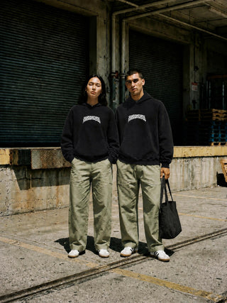 Models wearing the Paradigm 400 GSM mineral wash distressed hoodie in Misty Purple, street styled with wide leg pants