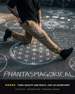 A person wearing tan jogger pants with white geometric line art walks across dark pavement marked with white chalk occult symbols and formulas. The pants have a zigzag stripe pattern near the upper leg.