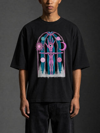 Male model wearing the black Dissolution of Ego oversized boxy sweater tee, front view showing the relaxed drop-shoulder fit