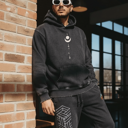 Model wearing black Existential snow wash hoodie with moon graphic and geometric joggers