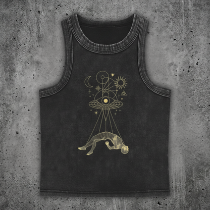 Black tank top with gold astrological design on a concrete surface