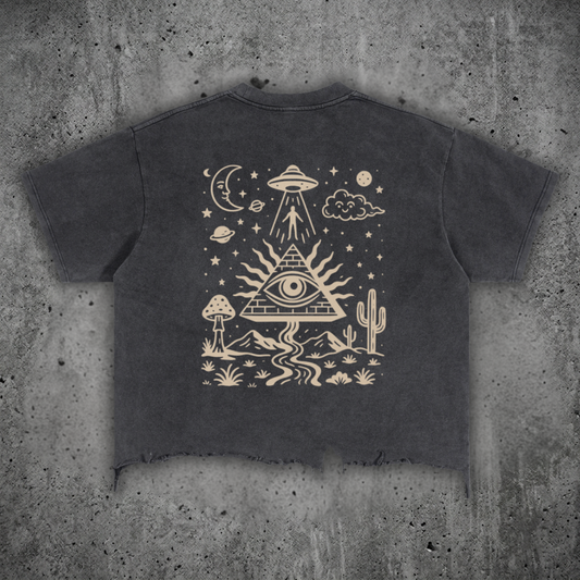 Dark gray t-shirt with a bronze graphic design on a concrete surface