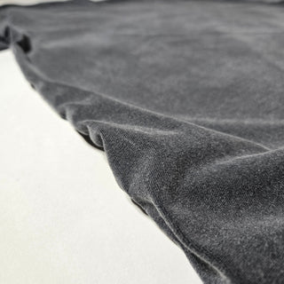 Dissolve The Ego Fluffy Vintage tee bottom hem close-up showing acid wash texture
