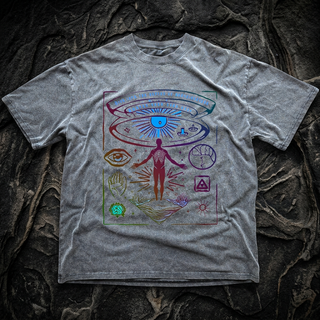 Heather gray Awaken Your True Self fluffy vintage heavyweight tee laid flat on dark stone, printed with a rainbow figure reaching upward beneath an all-seeing eye and esoteric symbols.
