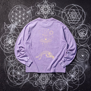 Back of the Dimensional Drift acid wash oversized long sleeve tee in Purple, styled on dark asphalt covered in white chalk sacred geometry, showing a cream and gold eye disc casting light onto a levitating figure.