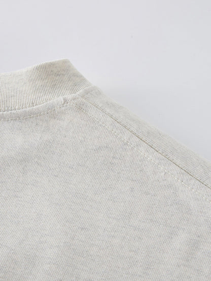 Dissolve The Ego oat gray 425 GSM tee shoulder seam close-up showing reinforced stitching
