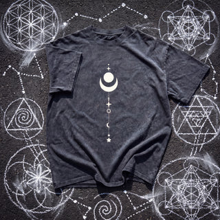 Dark gray Existential fluffy vintage washed heavyweight tee laid on chalk sacred geometry, printed in cream with a full moon cradled in a crescent and a celestial stack of stars and moons running down the chest.