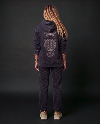 Model wearing the Existential snow wash hand-frayed heavyweight hoodie in Black, back view, showing the cream dragonfly, flower of life and all-seeing eye artwork down the back.