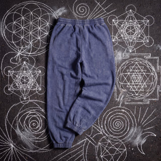 Back of the Existential Joggers in royal blue, 420 GSM snow wash, plain back with gathered elastic waistband and ribbed cuffs, on chalk sacred geometry.
