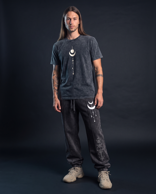 Model 6'0" and 165 lb wearing the charcoal Existential fluffy vintage washed heavyweight tee in size L with a cream crescent moon and celestial stack chest print, styled with matching Existential snow wash joggers.