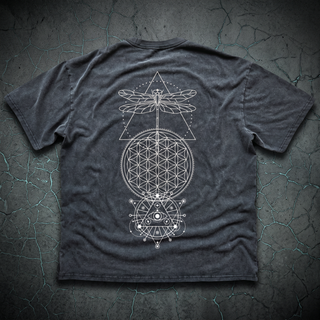 Back view of the charcoal Existential fluffy vintage washed heavyweight tee on dark charcoal concrete, printed in cream with a wide dragonfly over a Flower of Life mandala and an all-seeing-eye triangle.