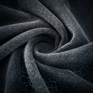 The Existential fluffy vintage washed fabric twisted into a swirl on dark charcoal stone, showing the cloudy vintage wash and soft brushed hand.
