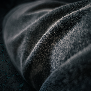 Macro of the soft brushed fluffy interior face of the Existential vintage washed cotton, raking light picking out the pile.