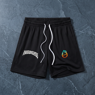 Black Nomenclature mesh drawstring shorts laid flat on dark slate, Phantasmagorical gothic wordmark on the left leg and the teal-to-orange pH flame logo on the right