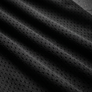 Macro of the 145 GSM black polyester athletic mesh showing the open perforated knit in soft diagonal folds
