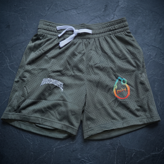 Army Green Nomenclature mesh drawstring shorts laid flat on dark charcoal slate, showing the perforated 145 GSM polyester mesh, elasticated waistband with white drawstring, the white Phantasmagorical gothic wordmark on the left leg and the teal-to-orange pH flame logo on the right.