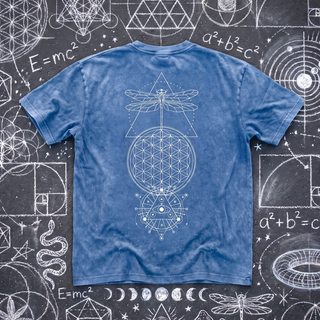 Back of the Existential snow wash oversized heavyweight tee in Light Blue, laid flat on dark asphalt covered in busy white chalk sacred geometry, printed in fine white line art with a dragonfly over a triangle, a large Flower of Life circle and an all-seeing eye mandala.