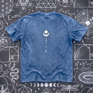 Front of the Existential snow wash oversized heavyweight tee in Light Blue, laid flat on dark asphalt covered in busy white chalk sacred geometry, with a small white crescent moon and star column printed at the center chest.