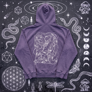 Lavender purple Embrace The Chaos snow washed loose cotton hoodie laid flat on wet chalk-covered pavement, back view with the white tangled serpent knot print, a Patakota collab.