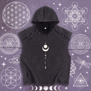 Front of the Existential snow washed boxy hooded tank top in black, laid flat on wet chalk-covered pavement drawn over with white sacred geometry, hood open showing the black lining, printed in white with a crescent moon cradling a circle above a dotted stack of stars.