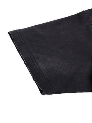Close-up of the short drop-shoulder sleeve showing the raw hand-frayed hem edge on faded black cotton