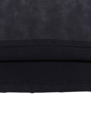 Close-up of the doubled bottom hem showing frayed stitching and the vintage wash fading from gray body to darker hem